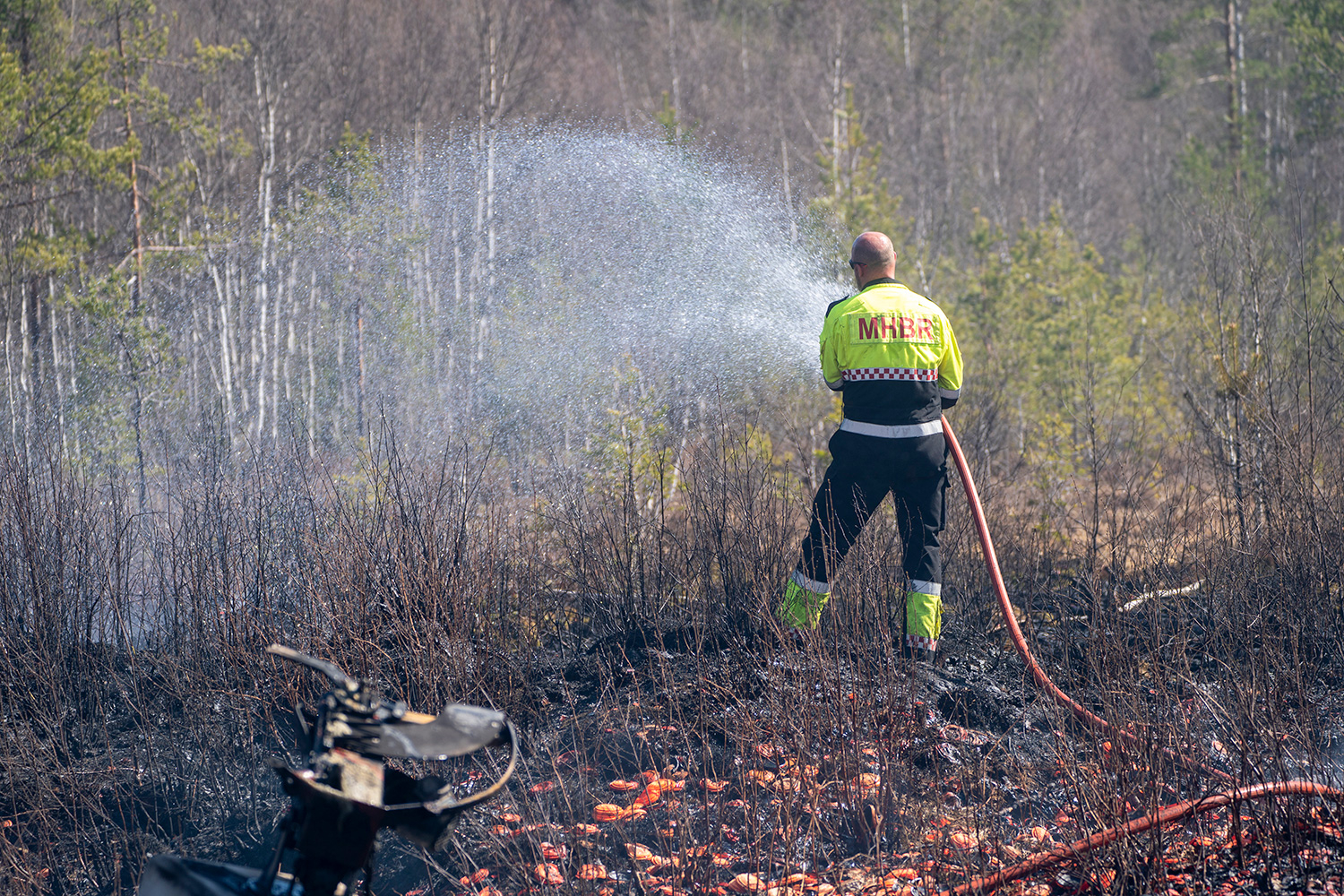 Skogbrannfaren på Øst- og Sørlandet vil øke i ukene fremover. Her slokker brannmannskaper en gressbrann på Terningmoen der forsvaret øvde med våpen. 